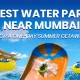 Friends on colorful tubes enjoying a water slide at Wet'nJoy, the best water park near Mumbai for a one-day summer getaway.