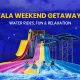 Promotional banner for a Lonavala Weekend Getaway Guide featuring Wet’nJoy Water Park. The image shows people racing down colorful multi-lane water slides with palm trees and a blue sky background. Text reads: 'Lonavala Weekend Getaway Guide: Water Rides, Fun & Relaxation