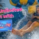 A happy woman sliding down a water slide at Wet’nJoy Water Park Lonavala with a Wet’nJoy Magic Pass for unlimited seasonal fun.