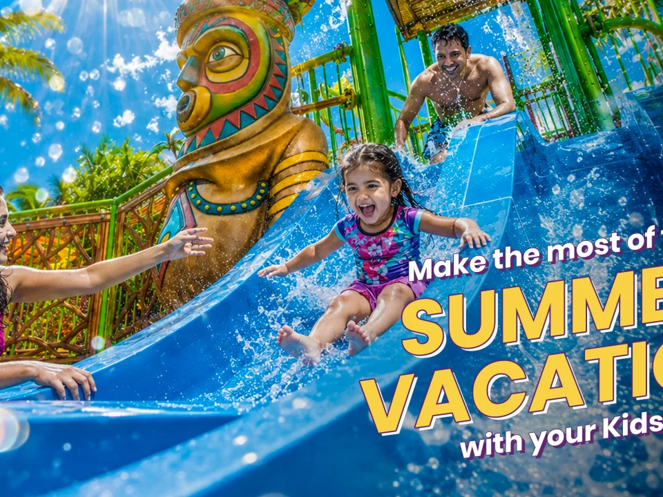 A family enjoying a blue water slide at Wet’nJoy Water Park Lonavala, one of the best places to visit in summer with kids near Mumbai and Pune.