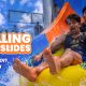 A group of people enjoying water slides and the rain at Wet'nJoy water park during a monsoon trip to Lonavala.