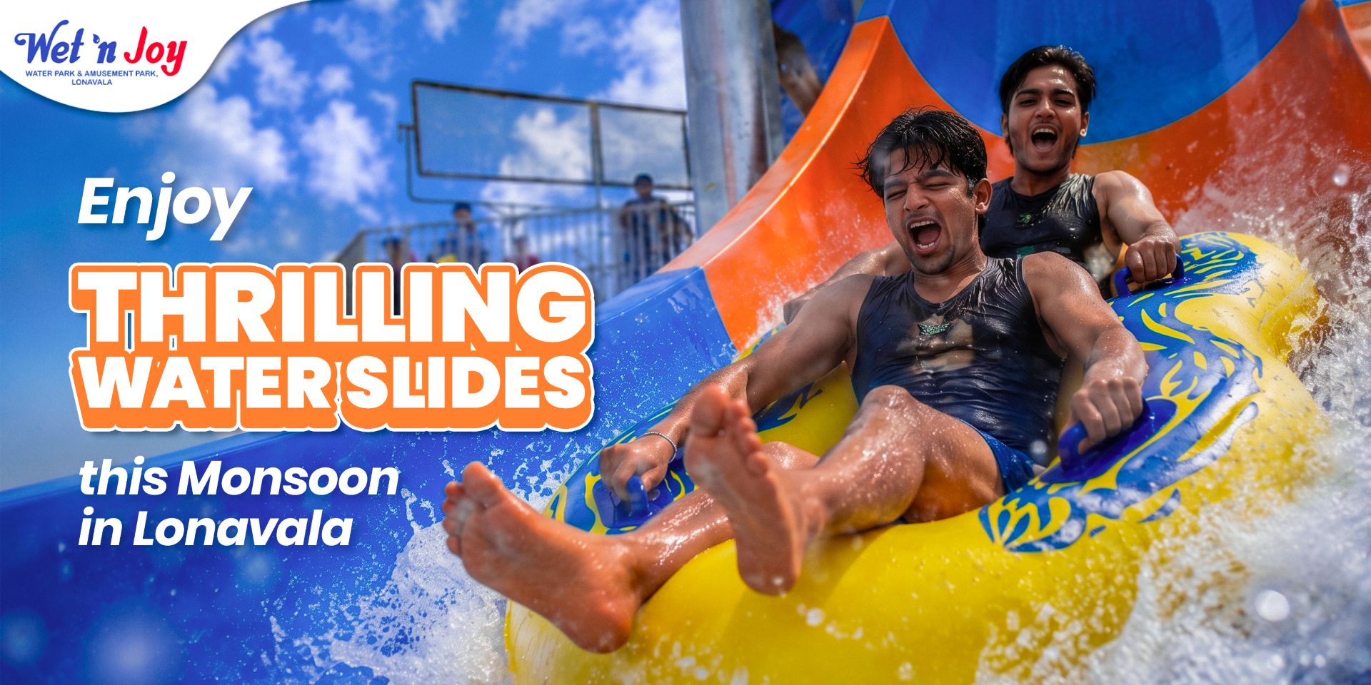 A group of people enjoying water slides and the rain at Wet'nJoy water park during a monsoon trip to Lonavala.