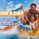 A happy family of four laughing and enjoying a thrilling water slide ride together on a yellow raft, highlighting fun family bonding activities and family outing ideas at Wet’nJoy Water Park, Lonavala.