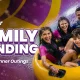 A joyful father laughing and sliding down a water slide on a yellow tube with his two excited young kids, showcasing fun father's day family activities and father's day celebration ideas near Mumbai and Pune at Wet'nJoy Lonavala.