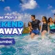 A group of young friends laughing, splashing, and wading through a wave pool during a weekend getaway near Mumbai in June to beat the summer heat at Wet'nJoy Water Park in Lonavala.